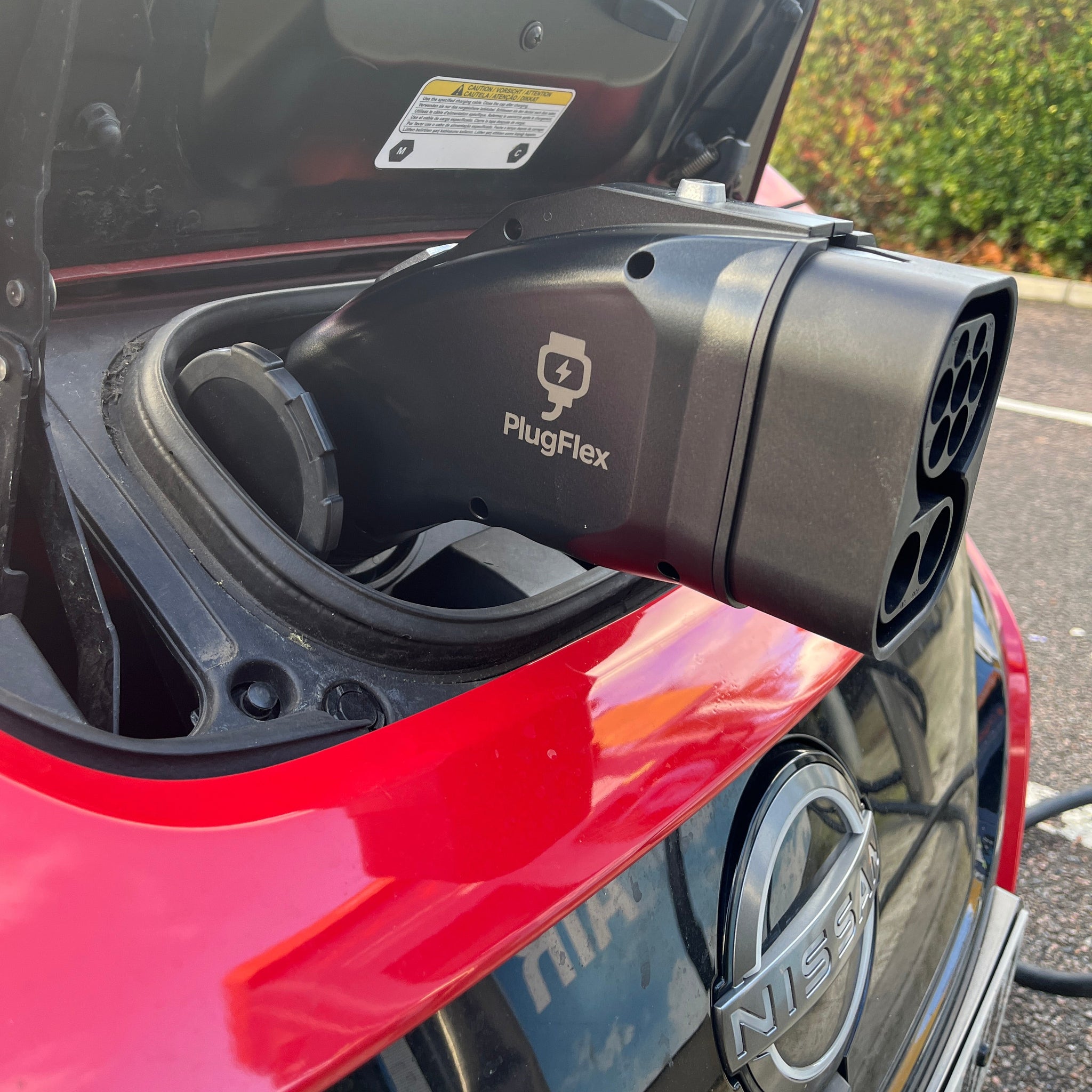 PlugFlex CCS to CHAdeMO adapter connected to an electric vehicle